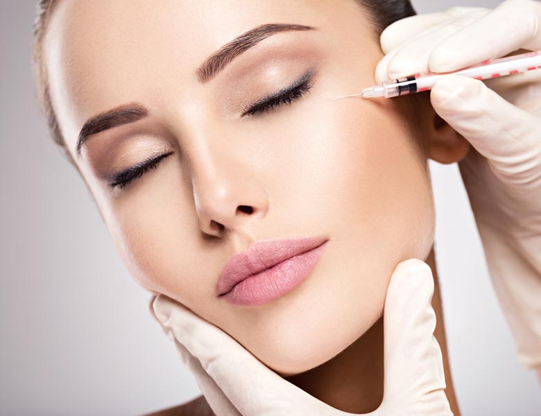 Woman getting cosmetic injection of botox near eyes